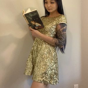 Gold/champagne sequin sparkle mini dress with deep V back. Fit and flare.